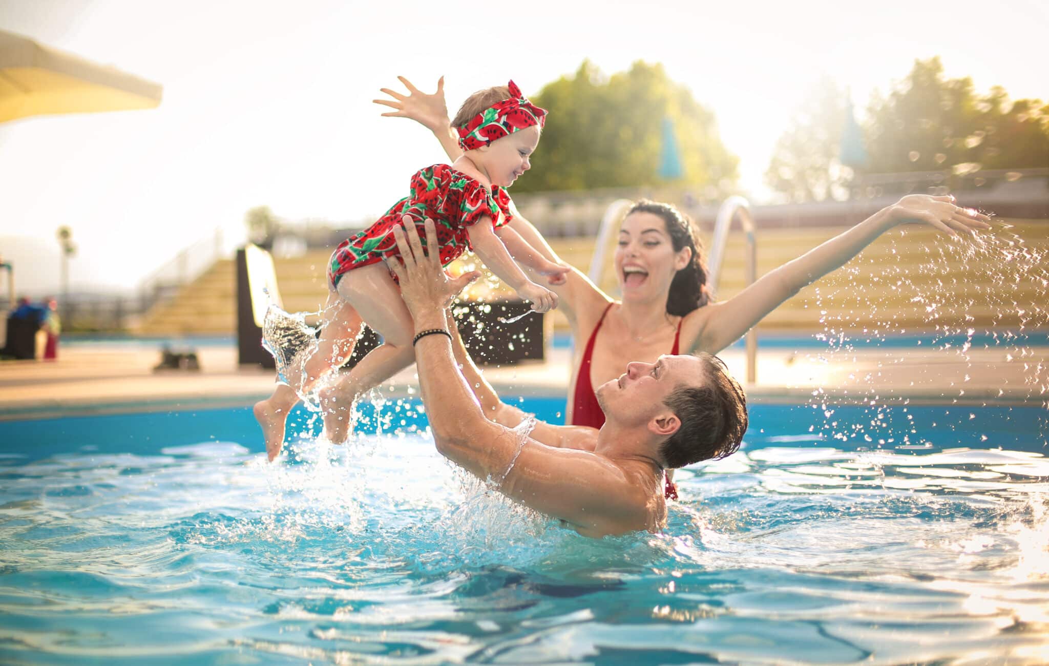 Beautiful family having fun in a swimming pool