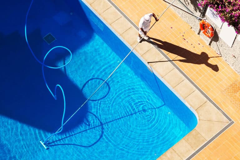 swimming pool cleaning to maintenance by lifeguard worker