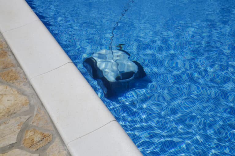 Cleaning the pool floor with an underwater vacuum cleaner, pool