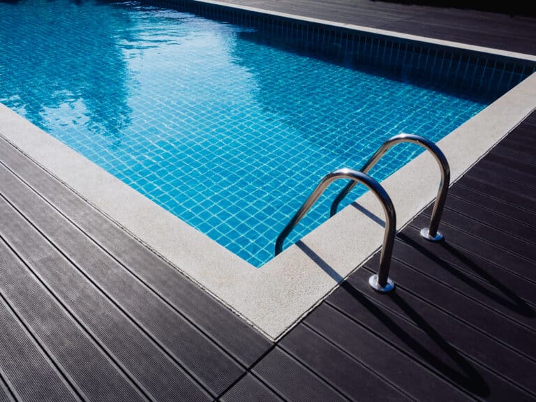 Stone edge frame on the square swimming pool with clean clear wa